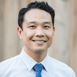 Char Hu in a light blue shirt and blue tie
