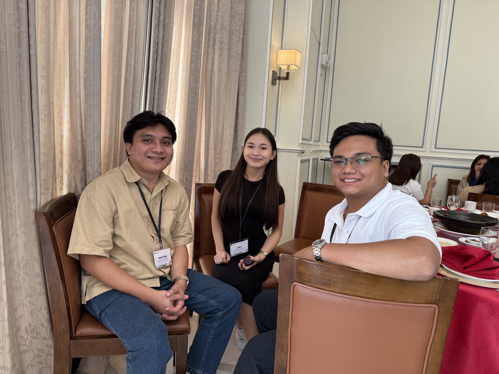 Three people seated together at a Chargeblast team gathering