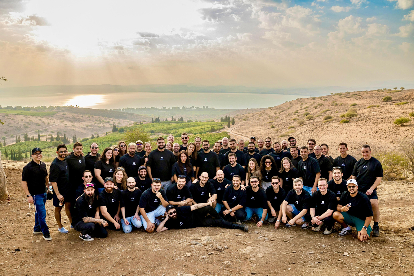 The Chargeflow team posing together on a hillside overlooking water