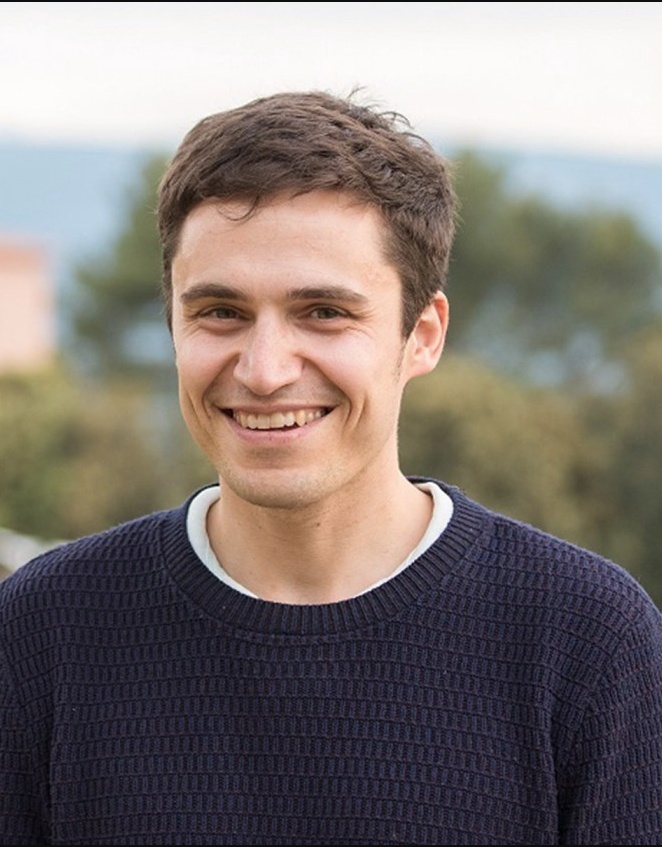 Charles Delingpole smiling outdoors in a navy sweater