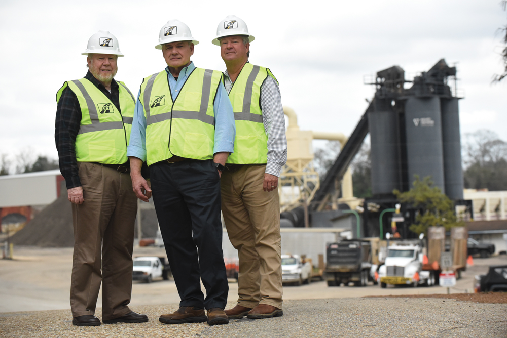 Alan Palmer, Charles Owens and John Harper in hard hats and safety vests at an asphalt plant