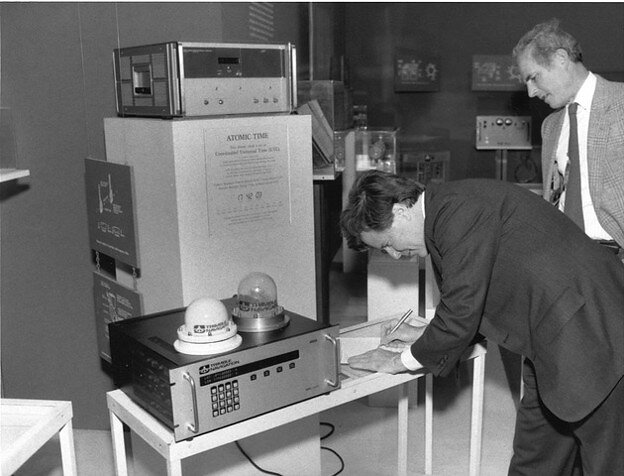 Charles Trimble signs a gift agreement at the Smithsonian for the company's first production GPS receiver.