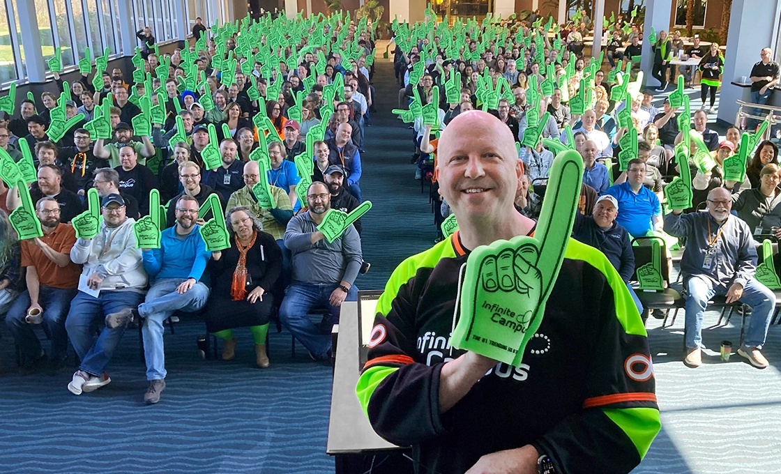 Charlie Kratsch with Infinite Campus employees gathered at a company celebration