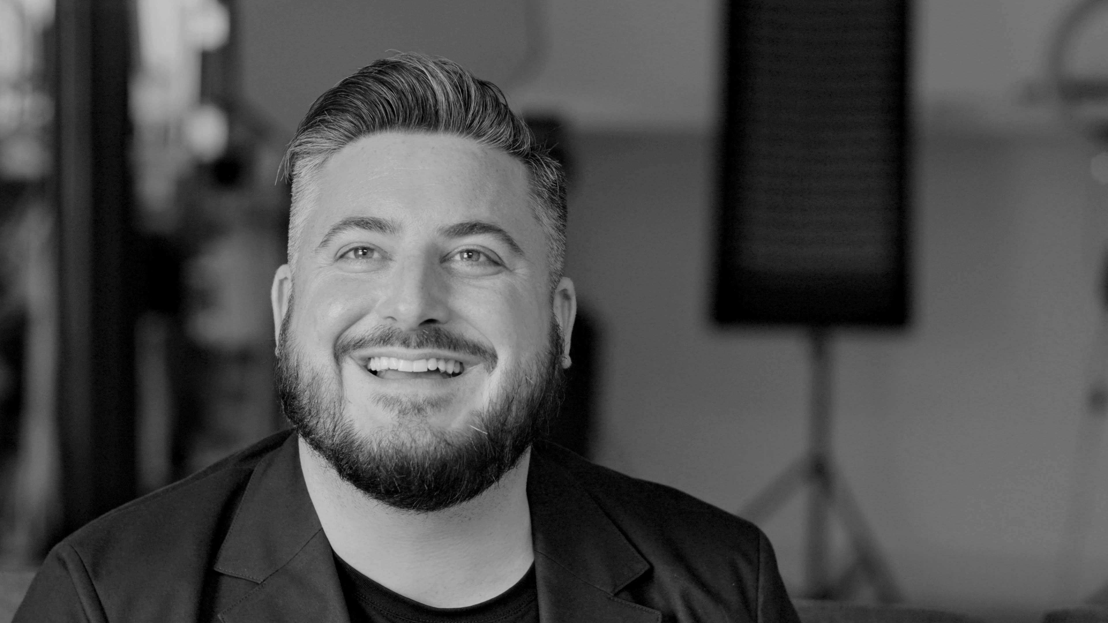 Charlie Wilkie smiling during a conversation
