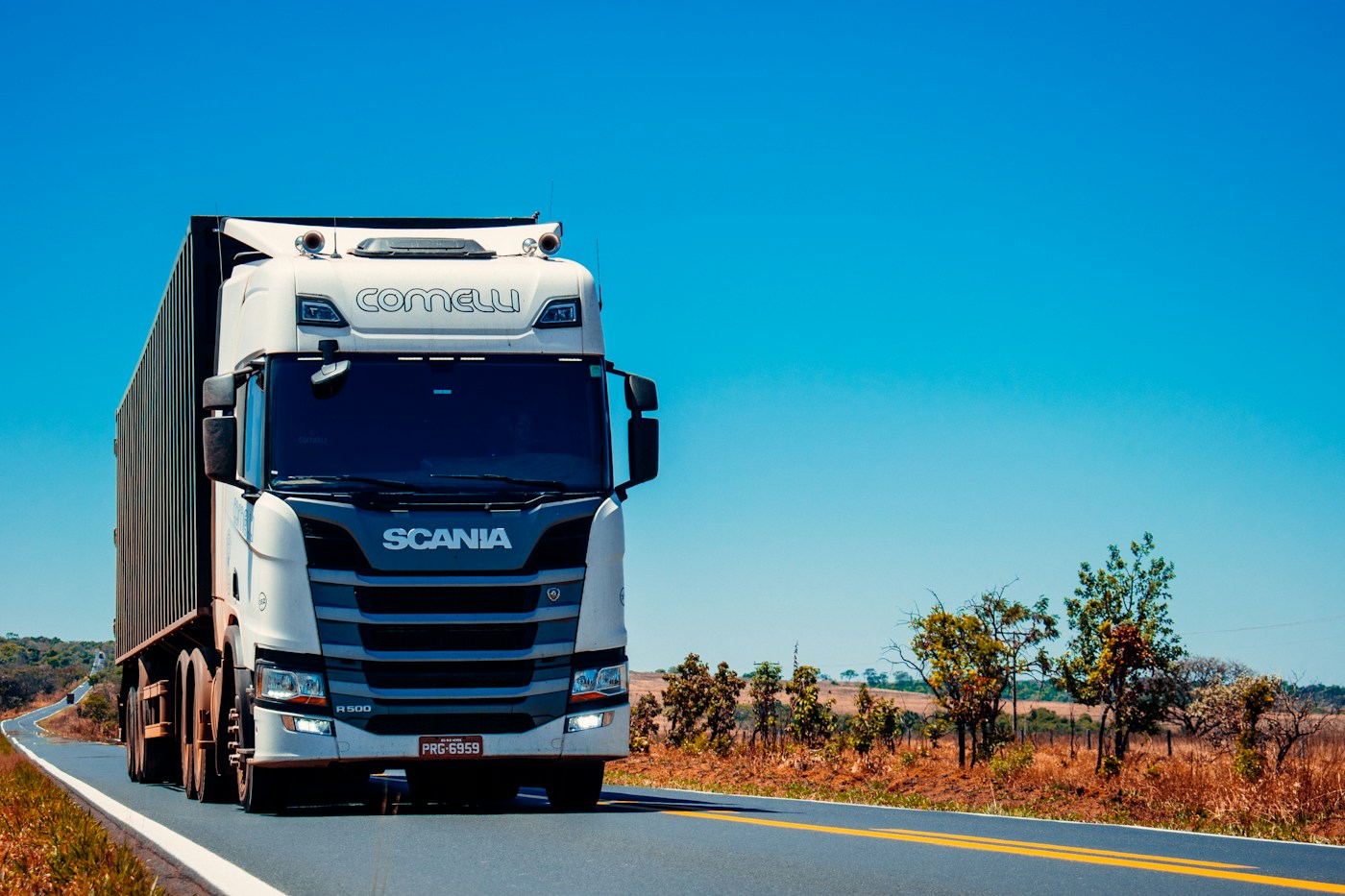 A freight truck travels on an open road