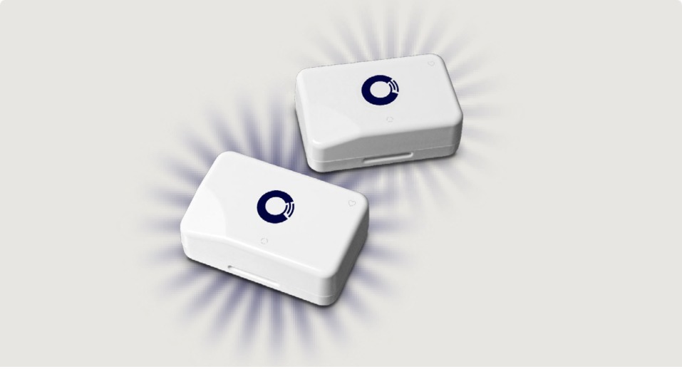 Two white Checkit wireless monitoring devices