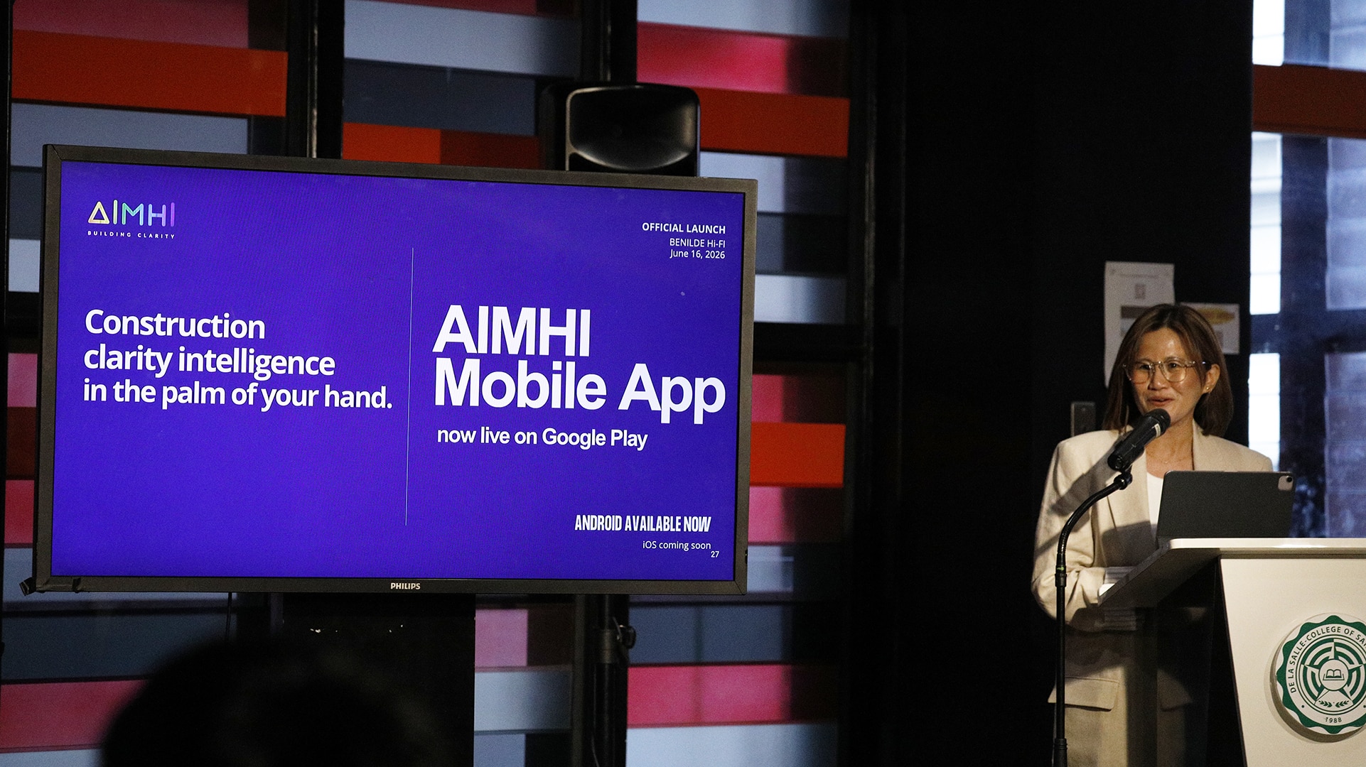 Cherryanne Lee Angoy presenting AIMHI Mobile beside its launch screen at Benilde