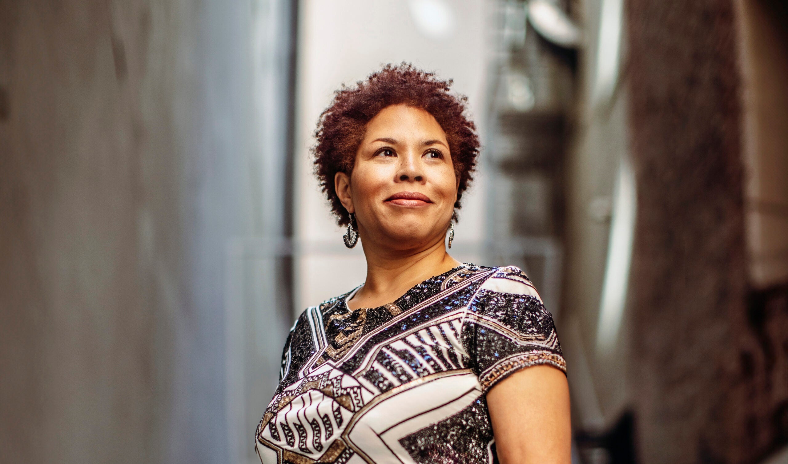 Cheryl Contee photographed outdoors against an architectural backdrop