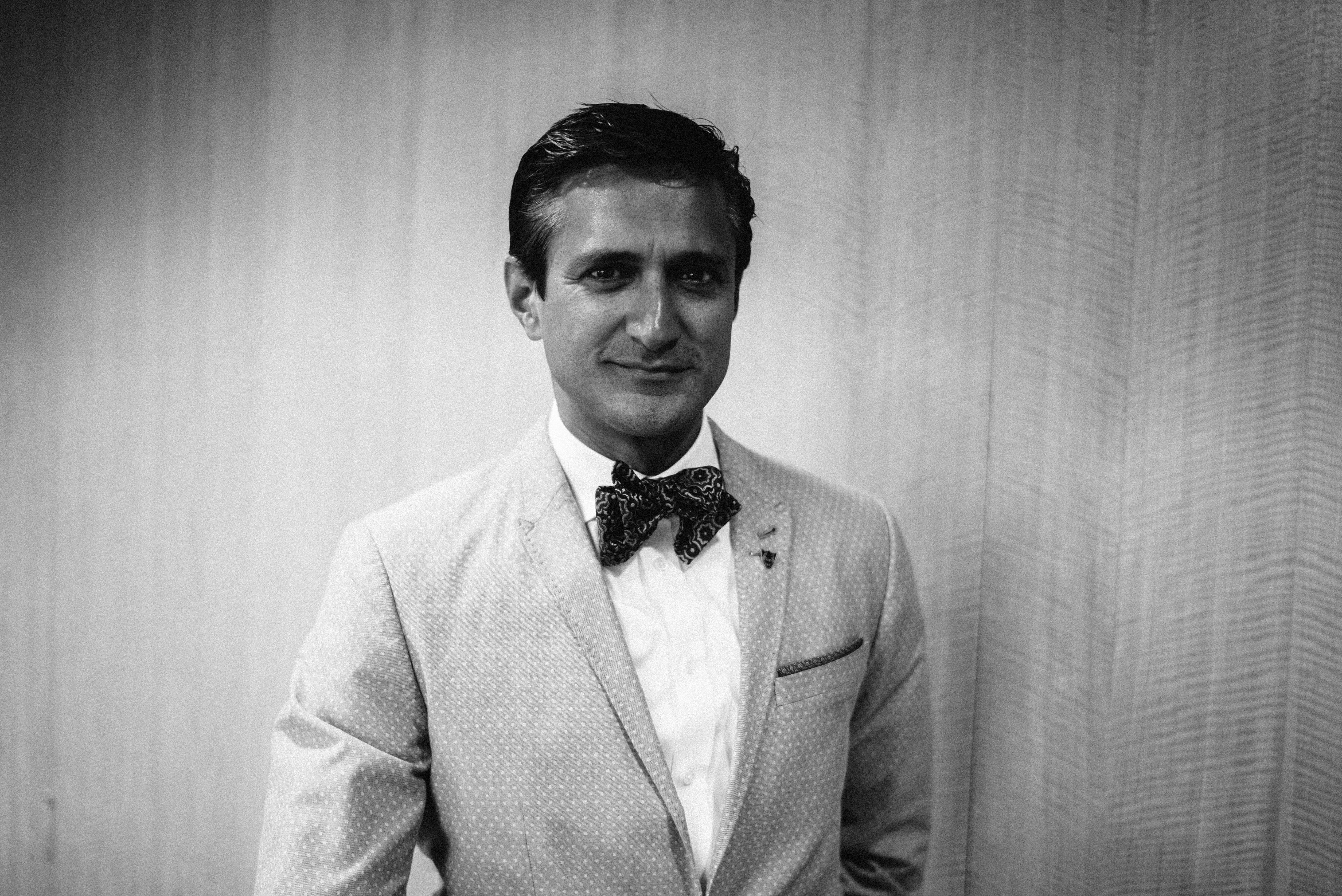 Chetan Dube in a patterned jacket and bow tie, photographed for Mike Walsh’s Between Worlds interview