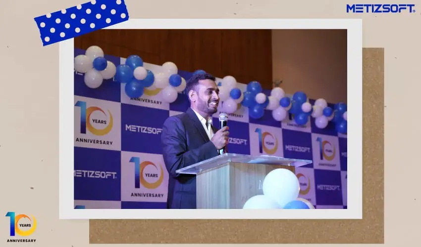 Chetan Sheladiya smiling while speaking at Metizsoft’s tenth anniversary celebration