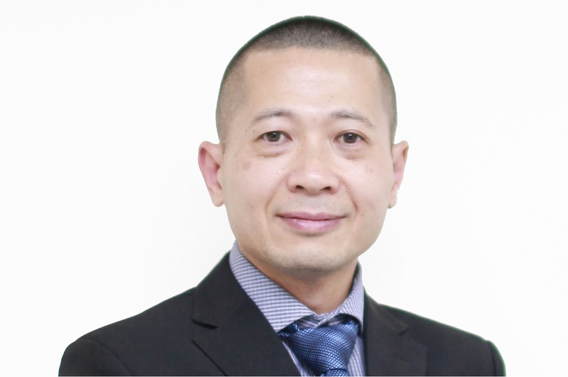 Chien Ta in a dark suit and patterned tie