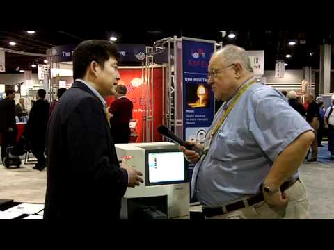 Ching Wu, at left, discussing an ion-mobility instrument with an attendee at Pittcon