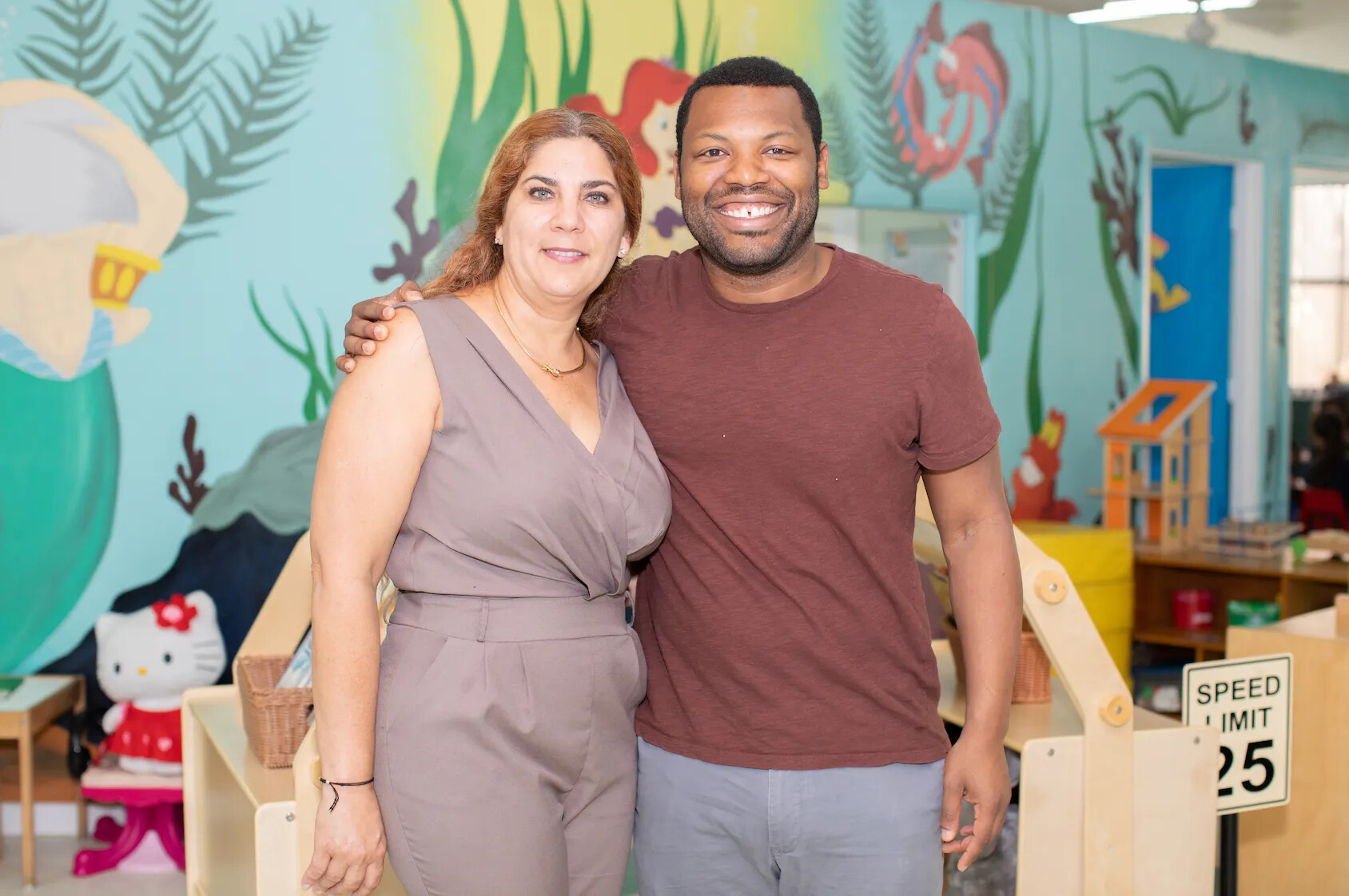 Chris Bennett standing with his childhood child care provider, Yoli