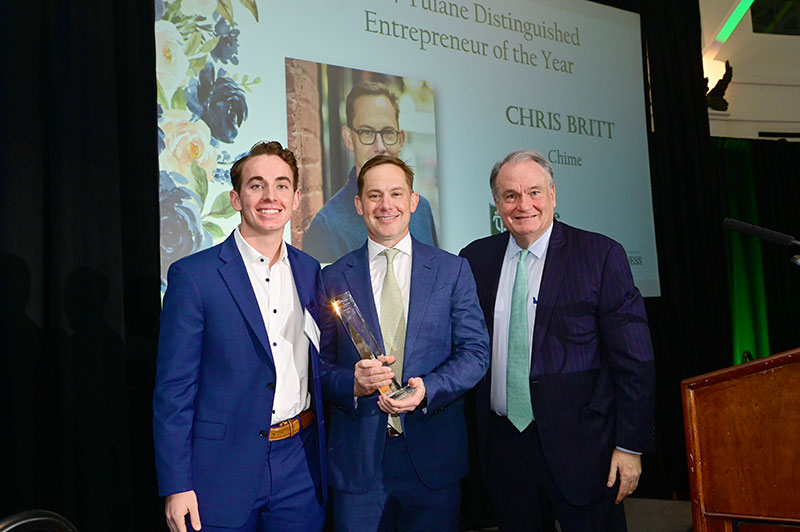 Clayton Britt, Chris Britt holding the Tulane Distinguished Entrepreneur of the Year award, and Tulane president Michael Fitts at the 2024 ceremony