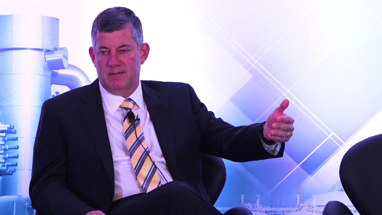 Chris Chandler seated onstage, gesturing during his ADI Forum interview