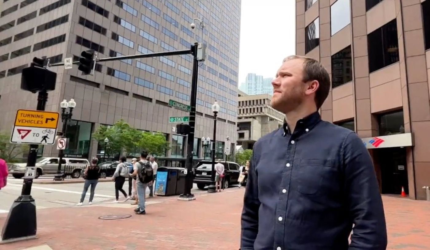 Chris Combs standing near the intersection of Congress Street and State Street in Boston