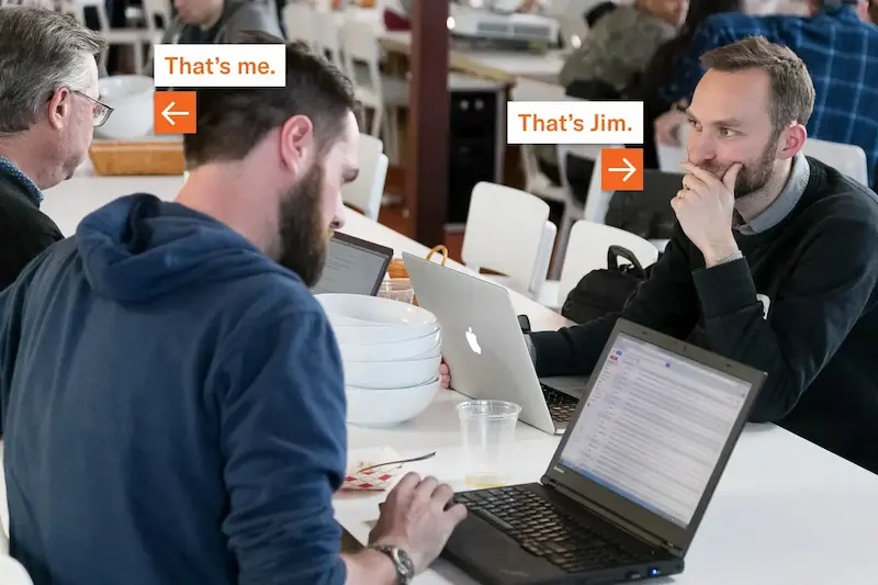 Chris Dean at left and Jim Brusstar at right working among laptops during their Y Combinator days