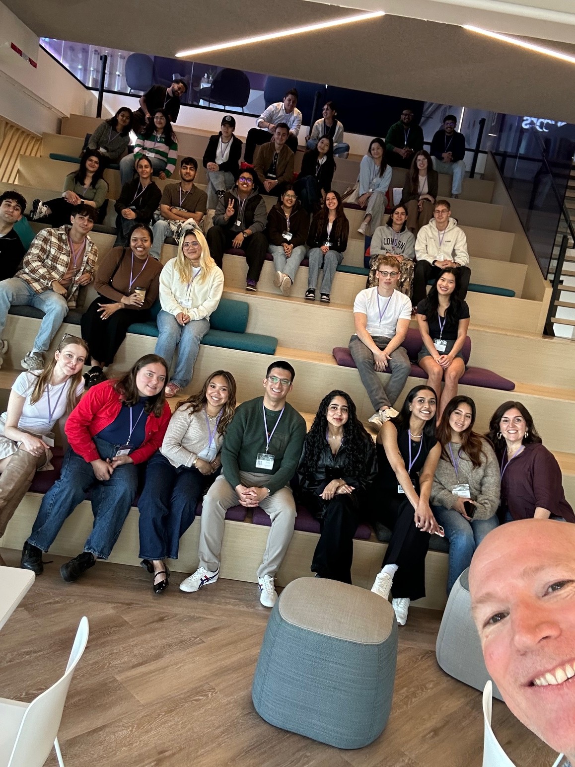 Chris Fudge taking a group selfie with Humber Polytechnic students during a visit to Achievers in Toronto