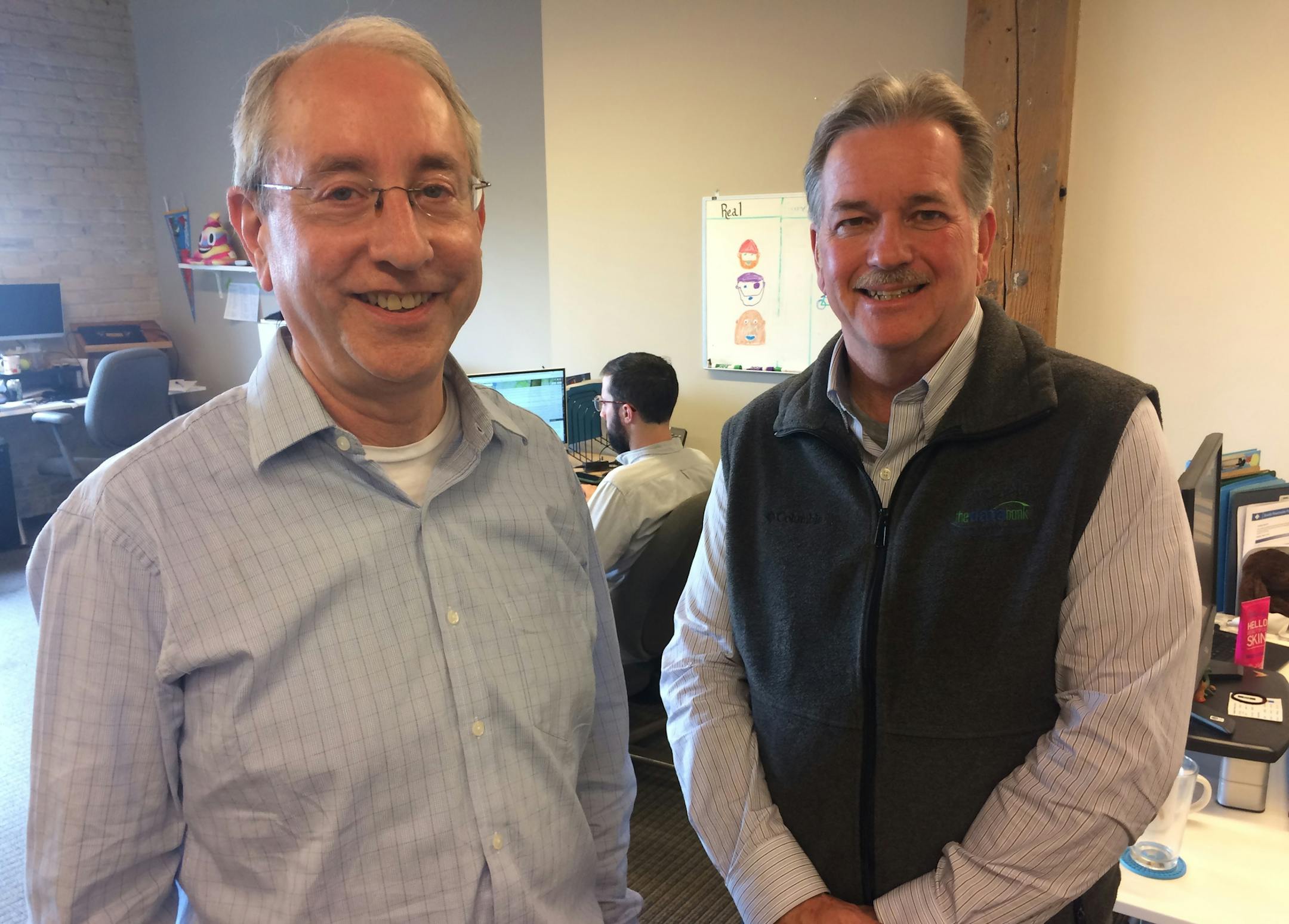 Mark Paquette and Chris Hanson standing together in thedatabank office