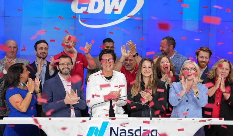 Chris Leahy, in a white jacket at centre, celebrates CDW’s IPO anniversary with coworkers at the Nasdaq opening bell.