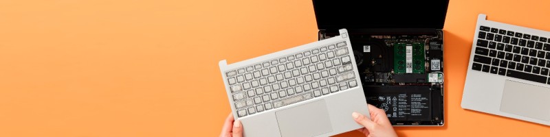 An open Framework laptop seen from above as its input cover is lifted away