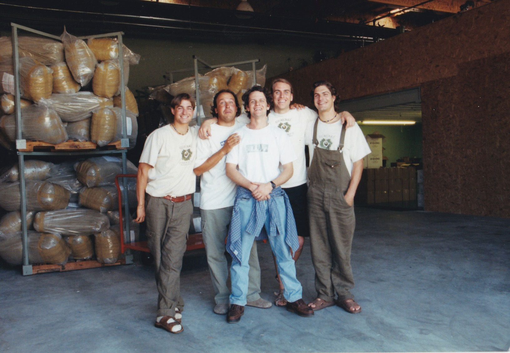 Guayakí's five founding partners together in a warehouse beside sacks of yerba mate