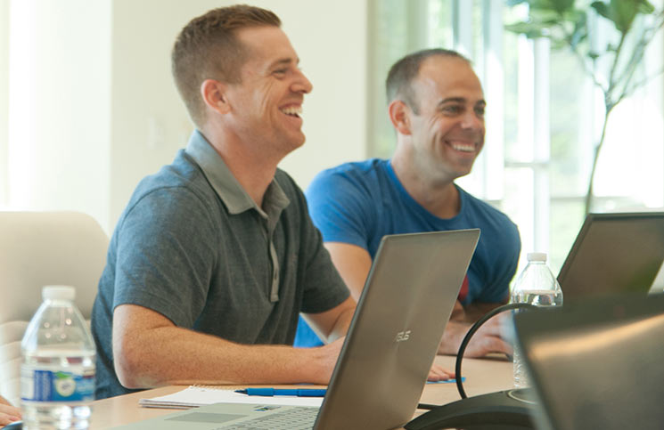Brian Gonsalves, left, and Chris Marantette seated at a meeting with laptops