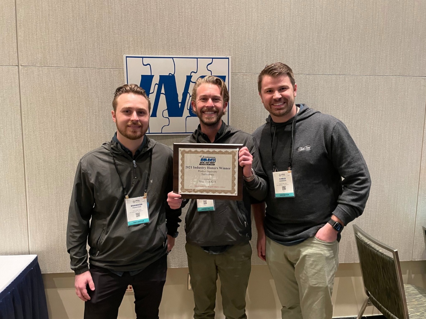Blue Tees co-founders Brandon Francisco, Drew Koehler, and Chris Markham, at right, holding their ING award at the 2022 PGA Show