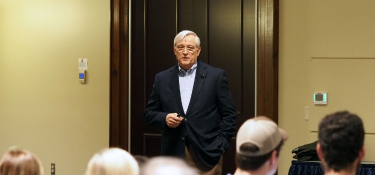 Chris Melton addressing an audience at the University of South Alabama
