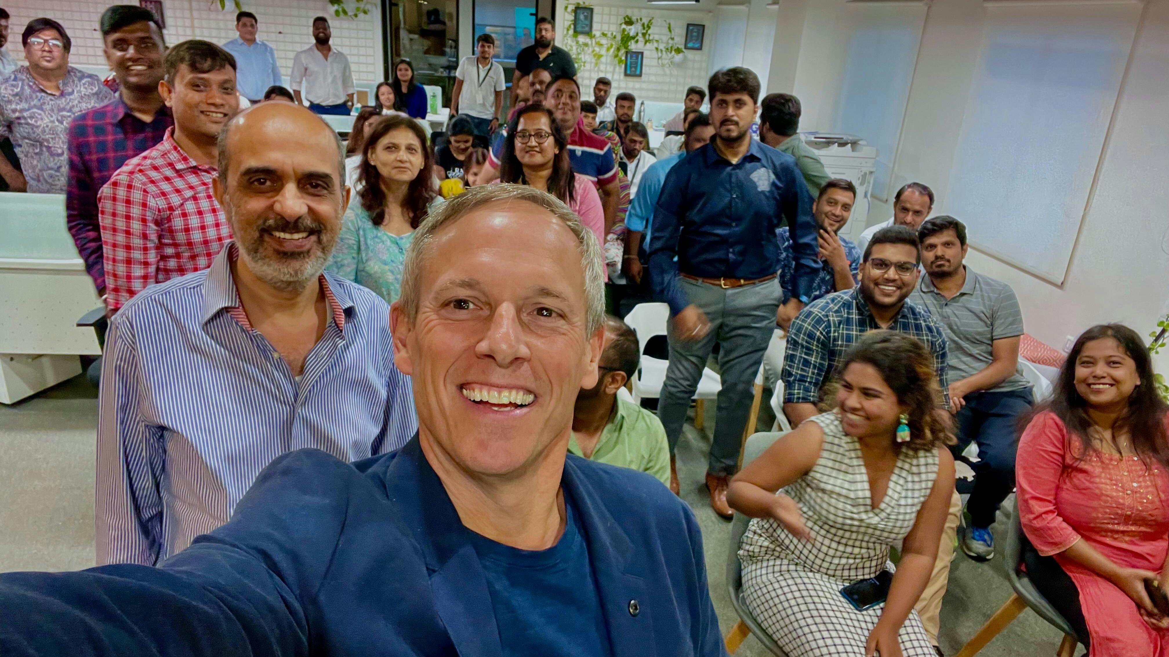 Chris Meyer smiling in the foreground of a group photograph with GPJ’s India team