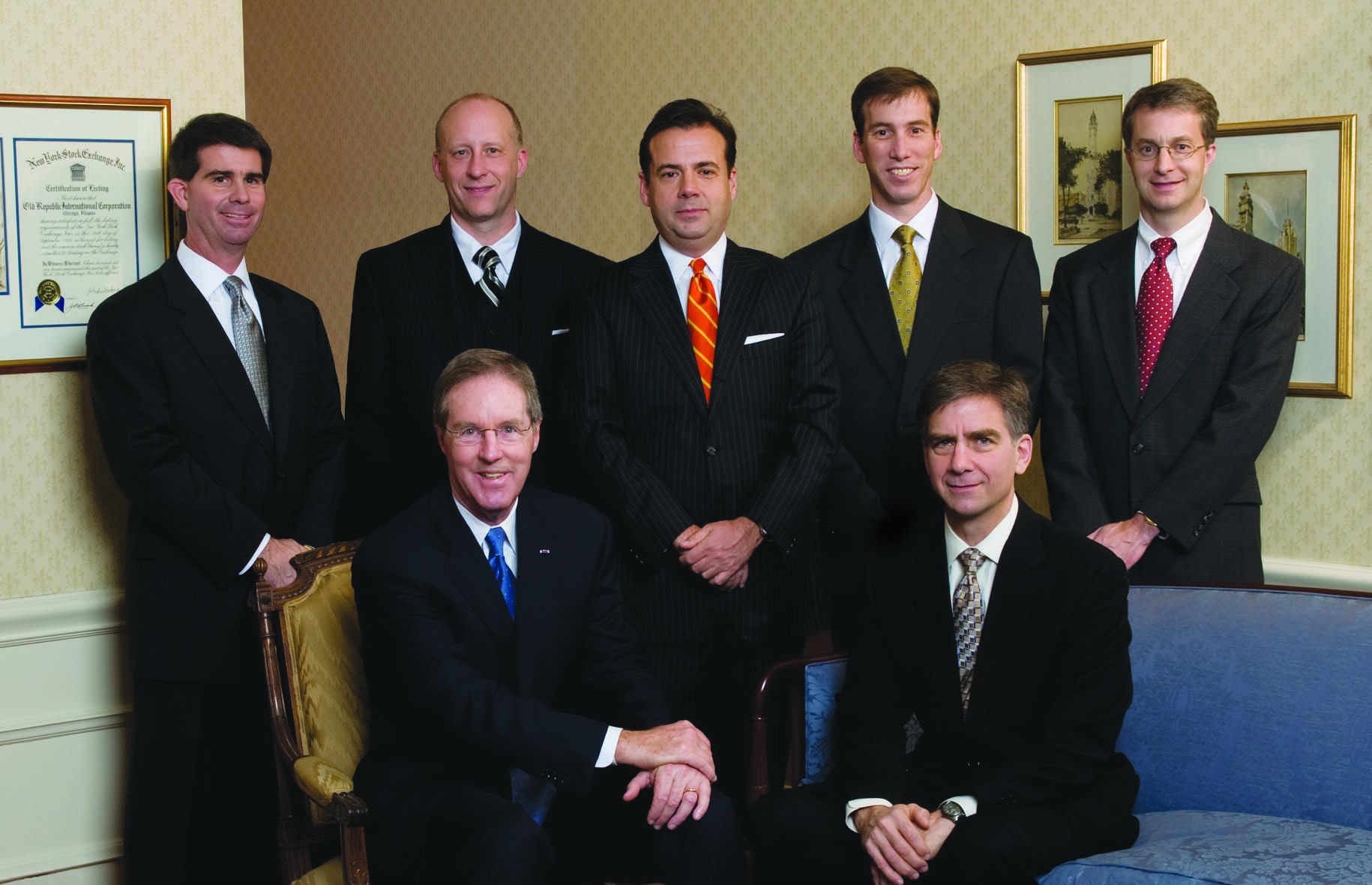 Seven Republic Mortgage Insurance executives in a formal group portrait in 2008, with Christopher Nard standing at center