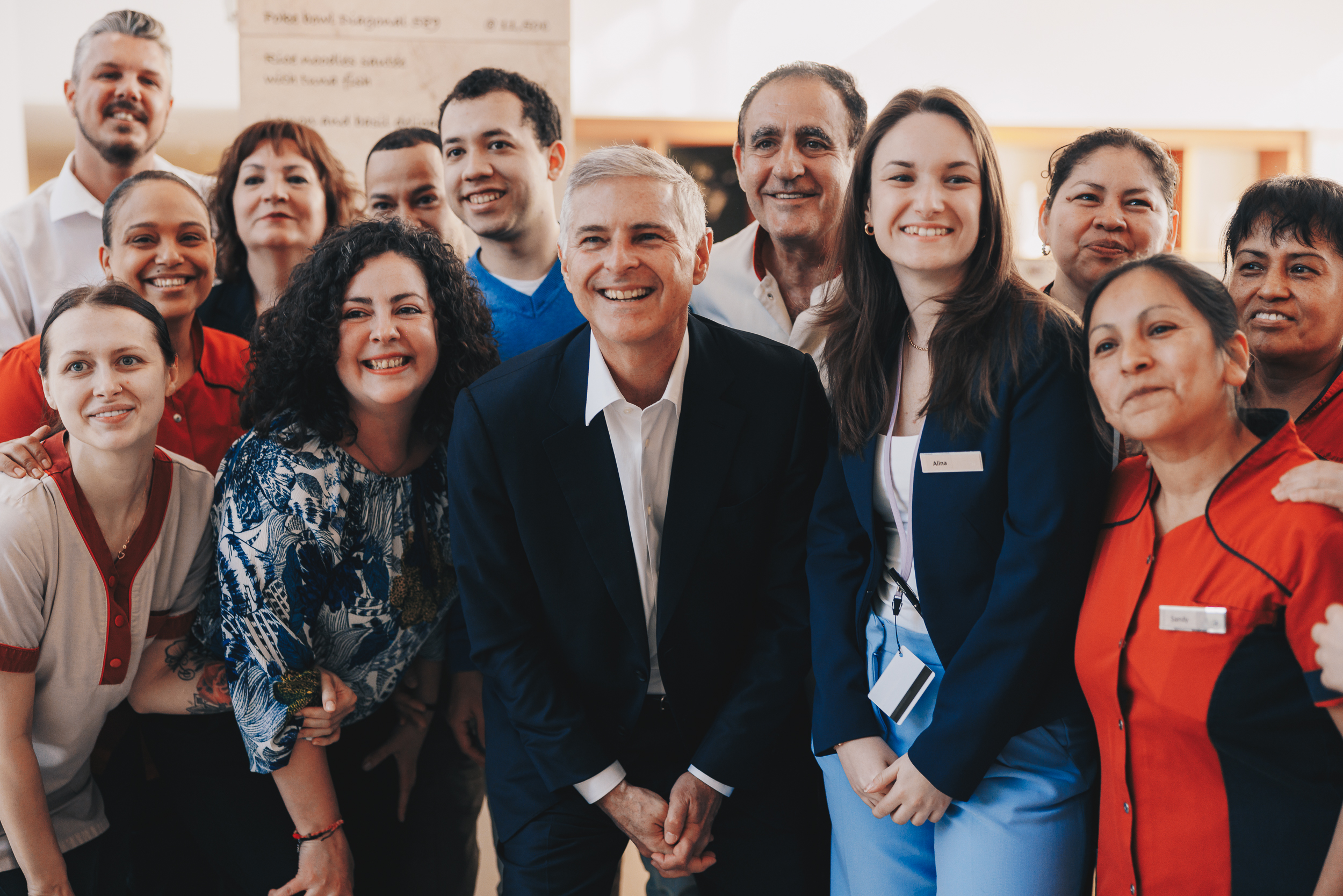 Chris Nassetta smiling alongside Hilton team members