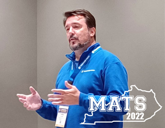 Chris Oliver gestures while presenting Trucker Path Dispatch at the 2022 Mid-America Trucking Show