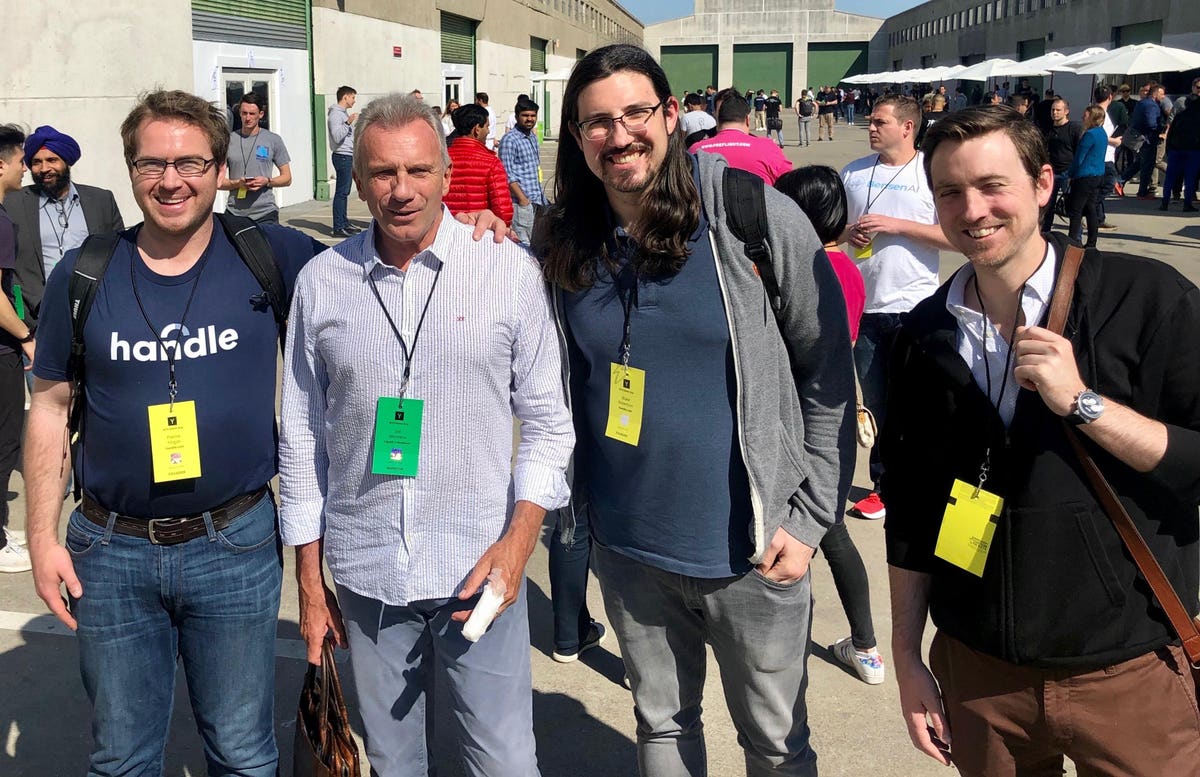 Patrick Hogan, Joe Montana, Blake Robertson and Chris Woodard standing together at a Y Combinator event