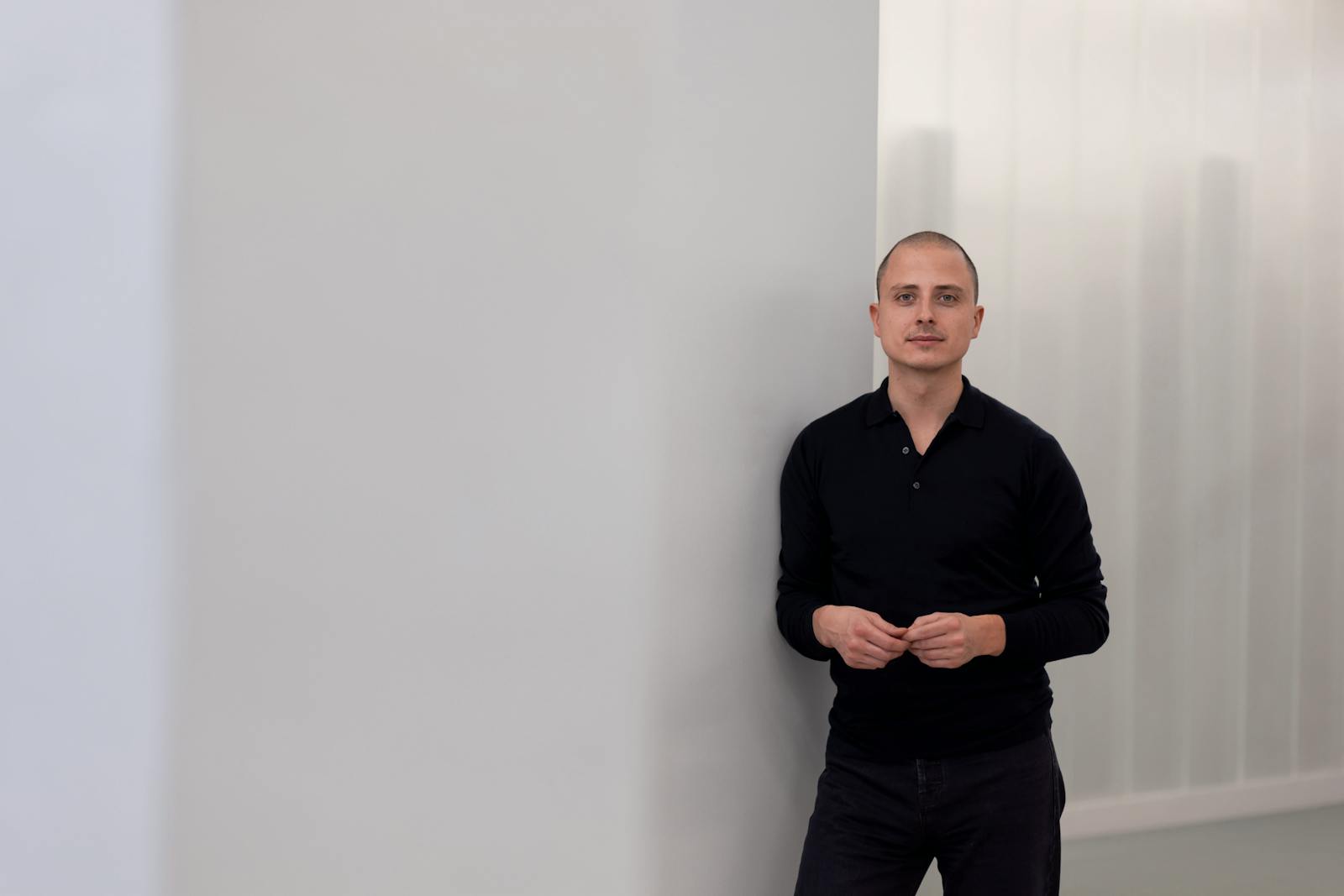 Christian Hecker standing against a pale wall at Trade Republic