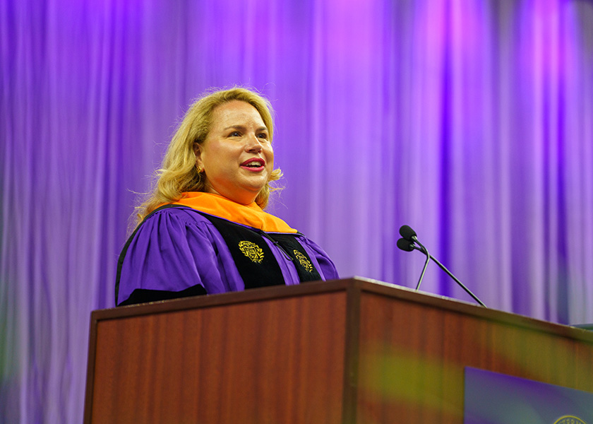 Christina Kosmowski speaking at Northwestern Engineering’s 2023 convocation in purple academic regalia