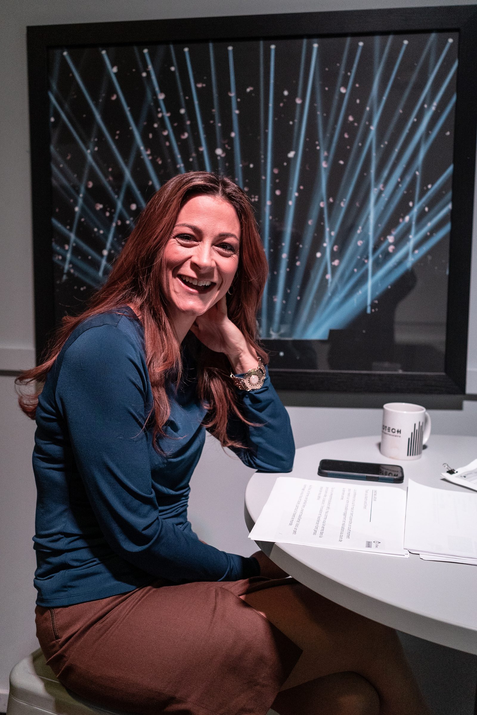 Christine Latour smiling while seated at a table during a working session