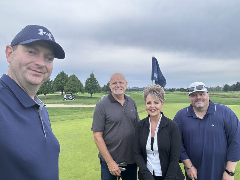 Christine Young with Darin Nessel, Stan Gorbanov, and Hill Issenman during a partner golf outing in Surrey, British Columbia