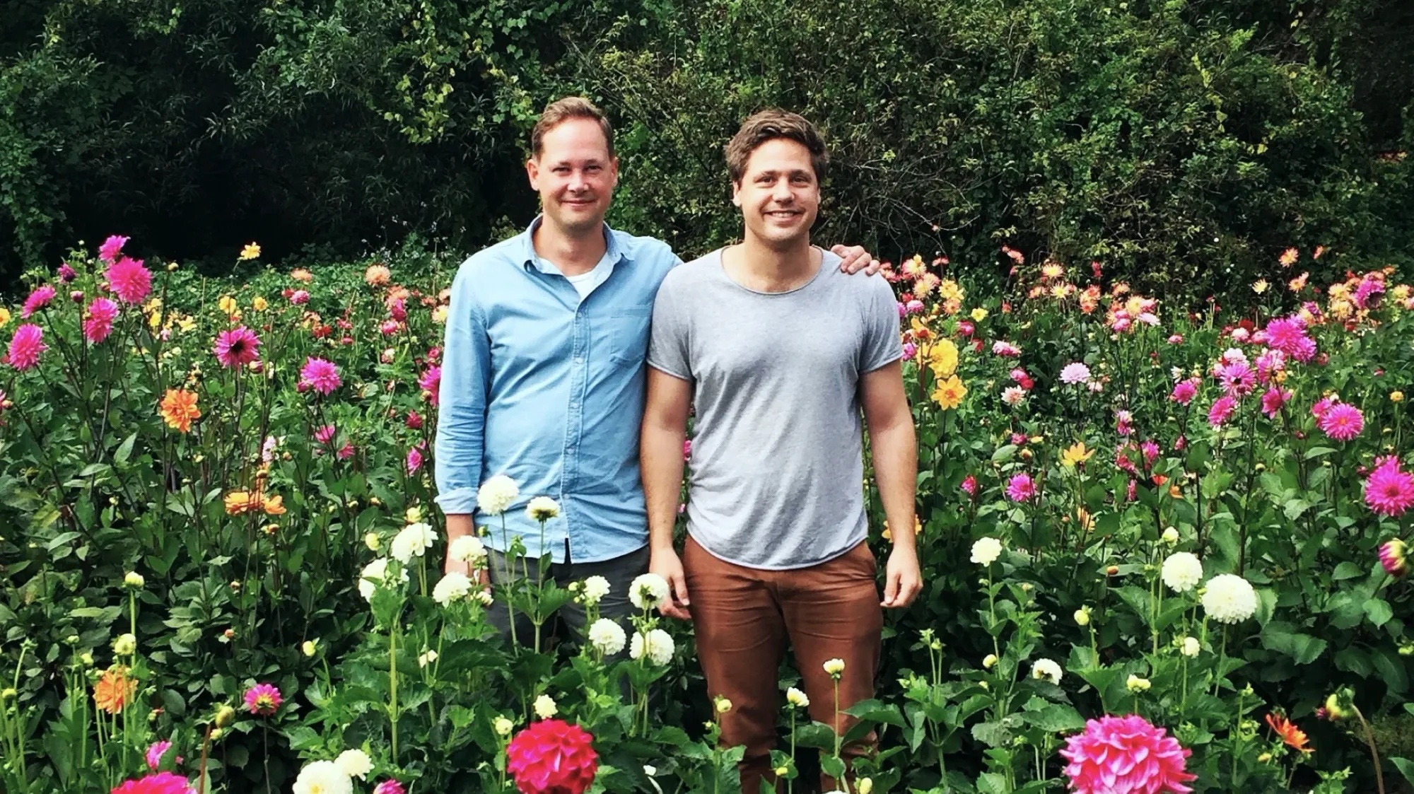 Jonas Klemming and Christoffer Klemming standing together in a flower garden