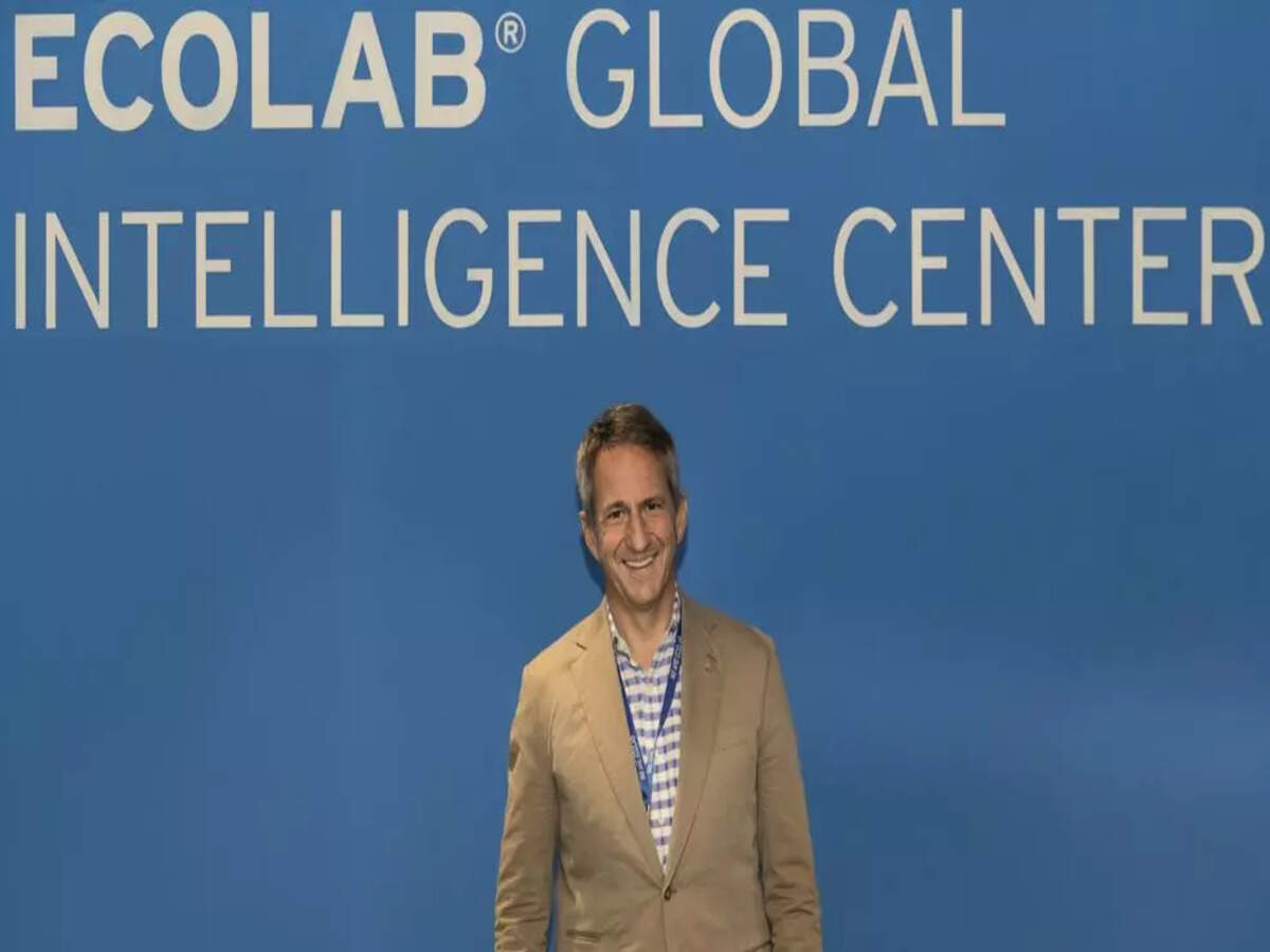 Christophe Beck standing in front of the Ecolab Global Intelligence Center sign in Pune