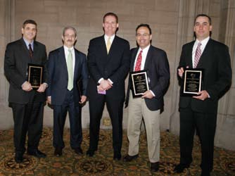 Five men at the Turnaround Management Association awards presentation; Christopher Atayan stands fourth from left