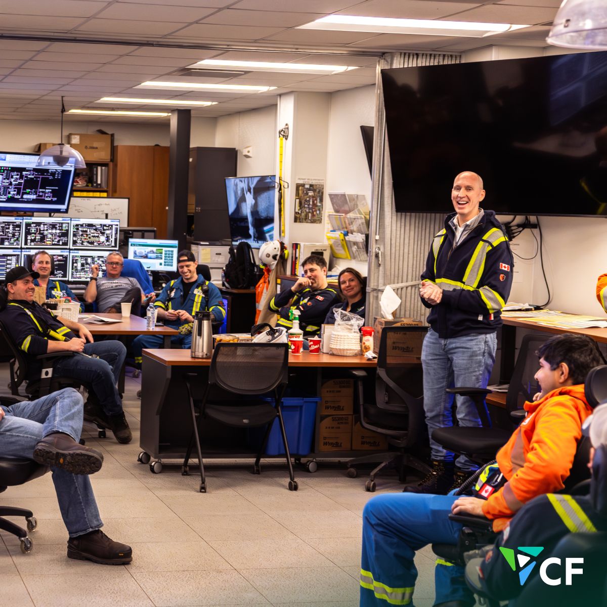 Chris Bohn smiles while meeting employees in a control room at CF Industries’ Medicine Hat Complex