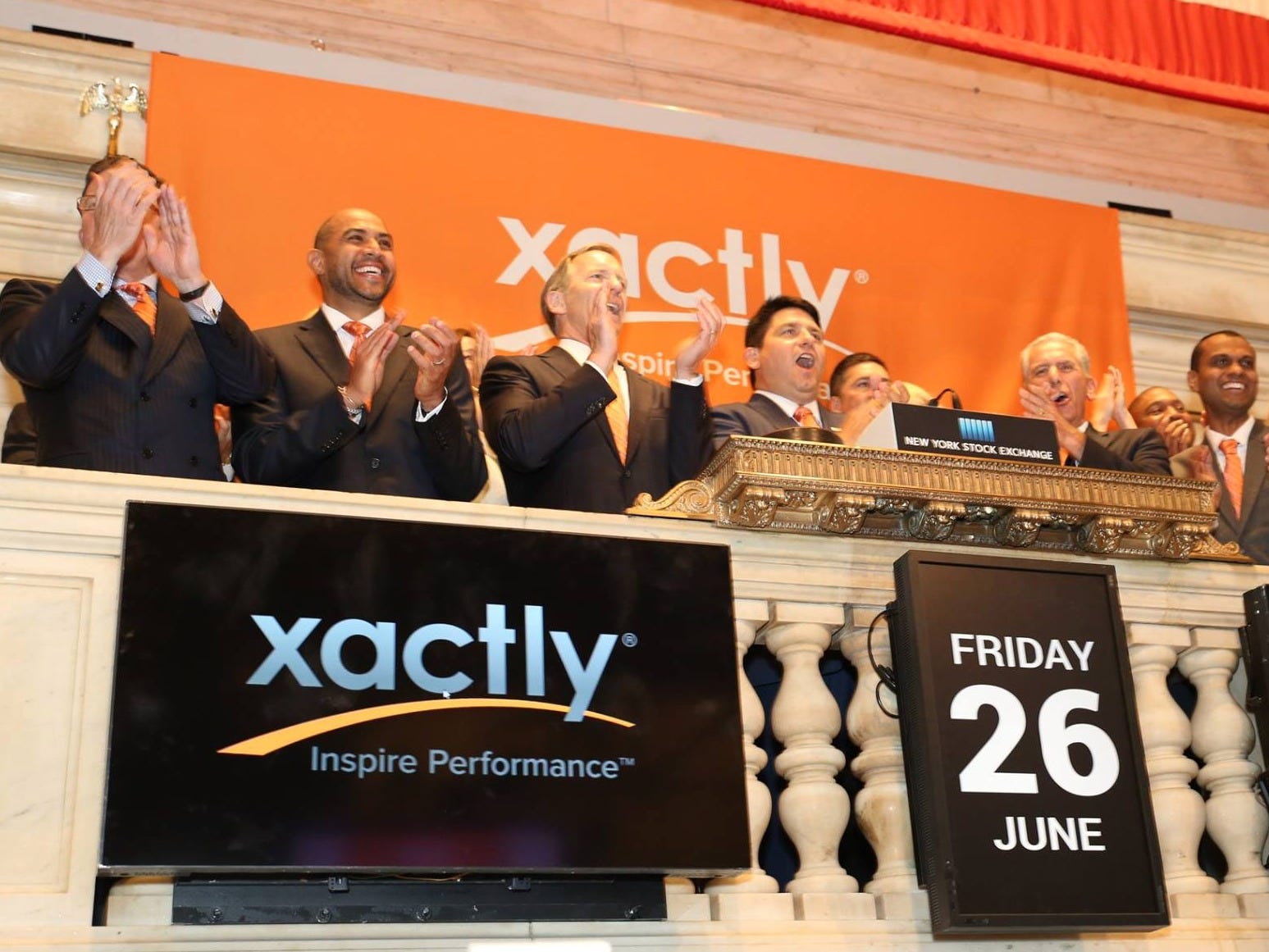 Chris Cabrera and the Xactly team applauding on the New York Stock Exchange balcony at the company's June 26, 2015 listing