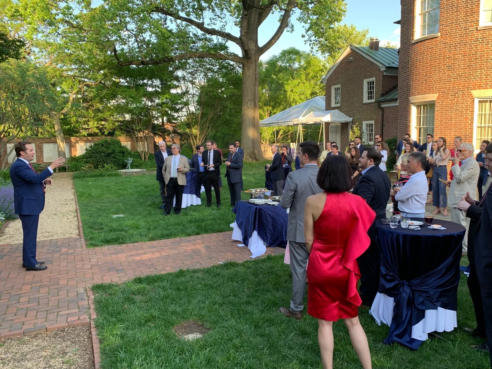 Christopher Sheeron addressing guests in the garden at Dumbarton House during Grayson's third-anniversary reception