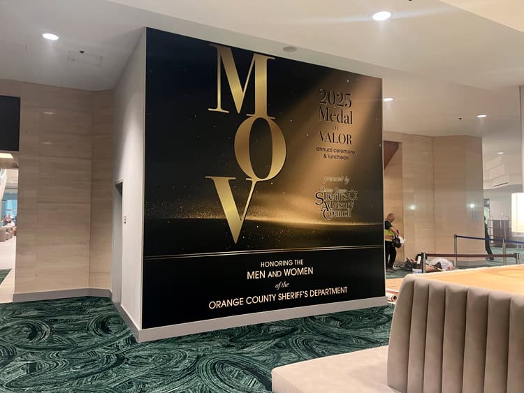 Black and gold wall graphic for the 2025 Medal of Valor ceremony, shown in Graphics360’s project portfolio