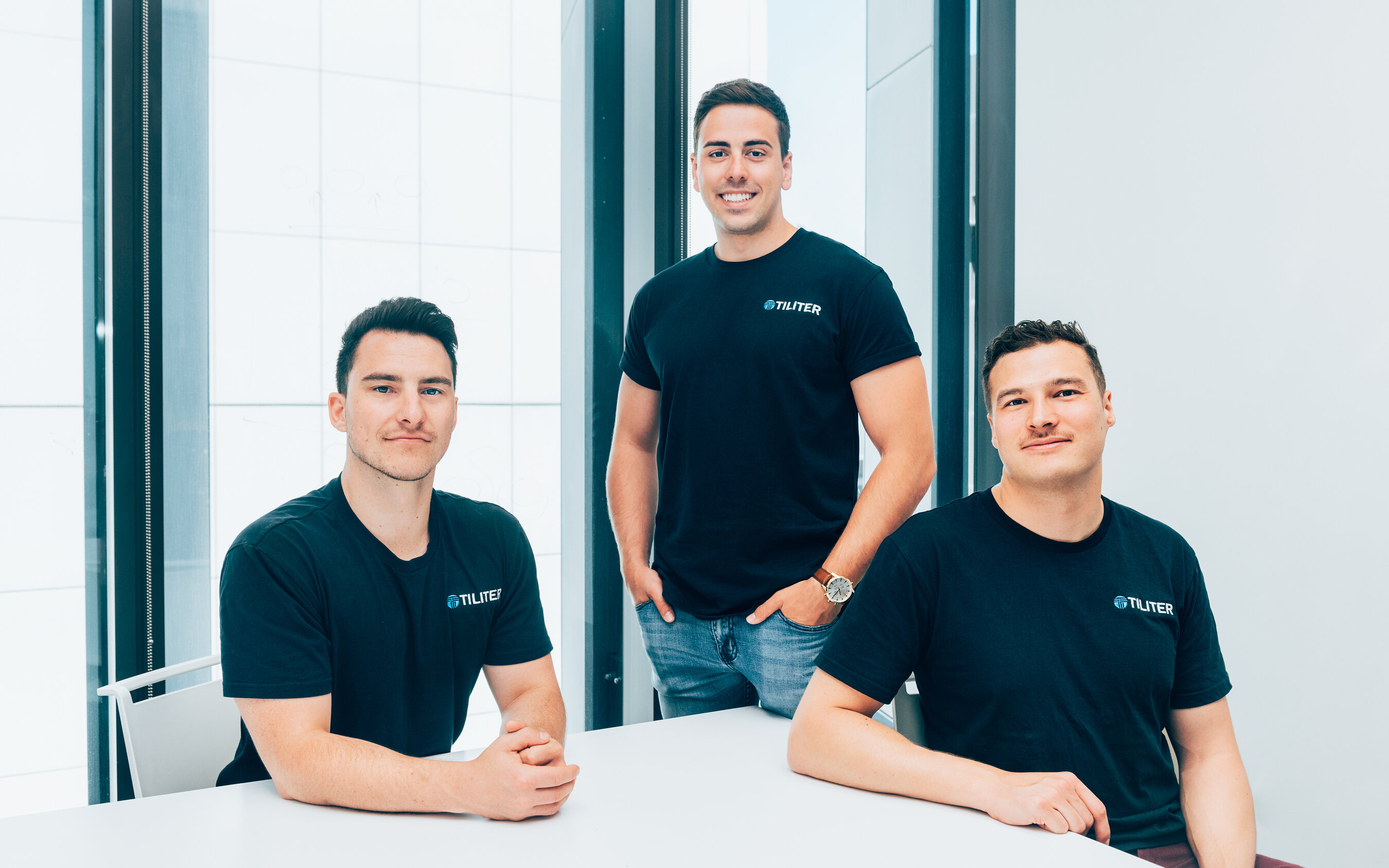 Tiliter co-founders Chris Sampson, Martin Karafilis and Marcel Herz together in black Tiliter shirts