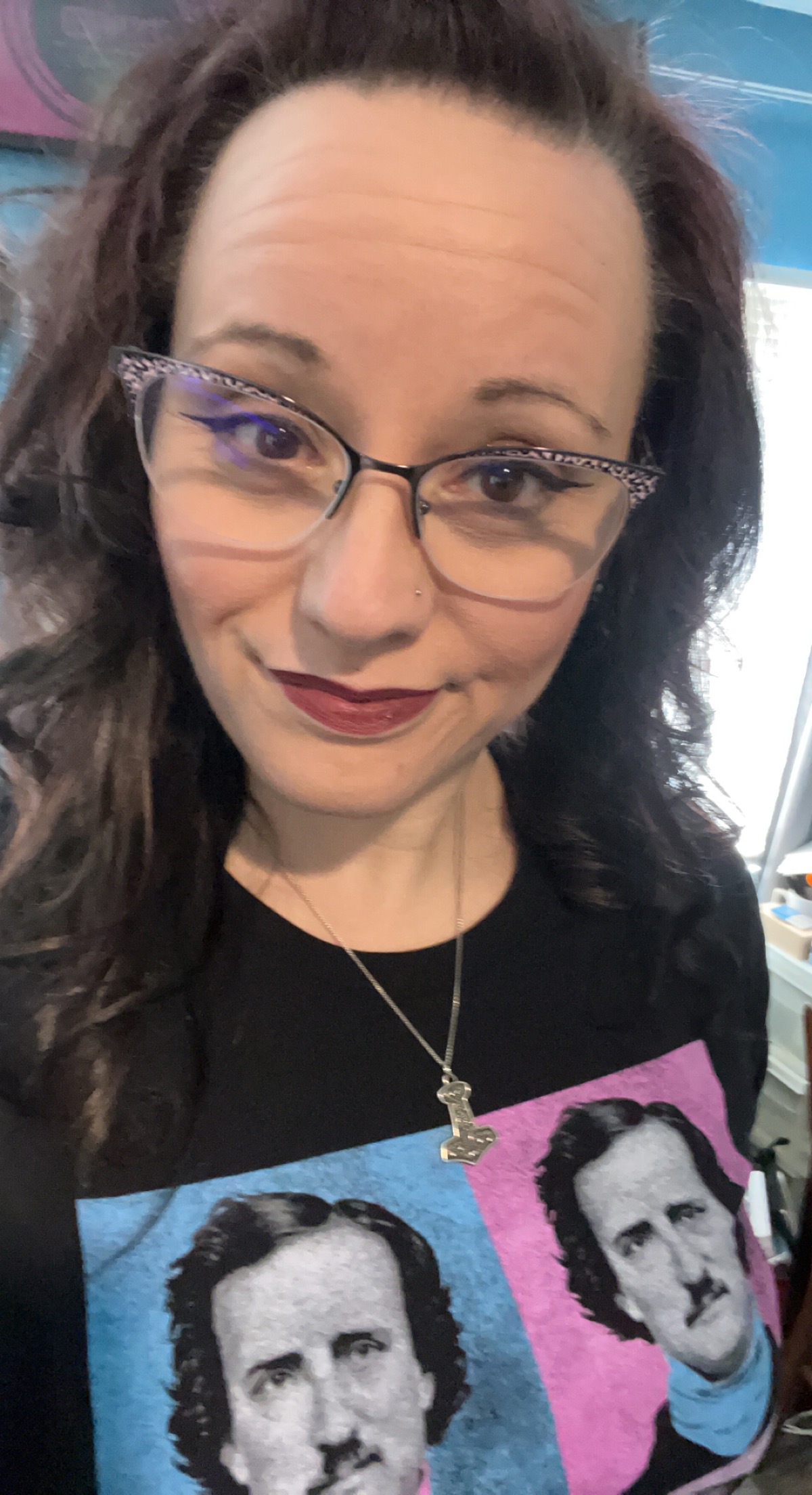 Chrystal Mahan wearing glasses and an Edgar Allan Poe print shirt