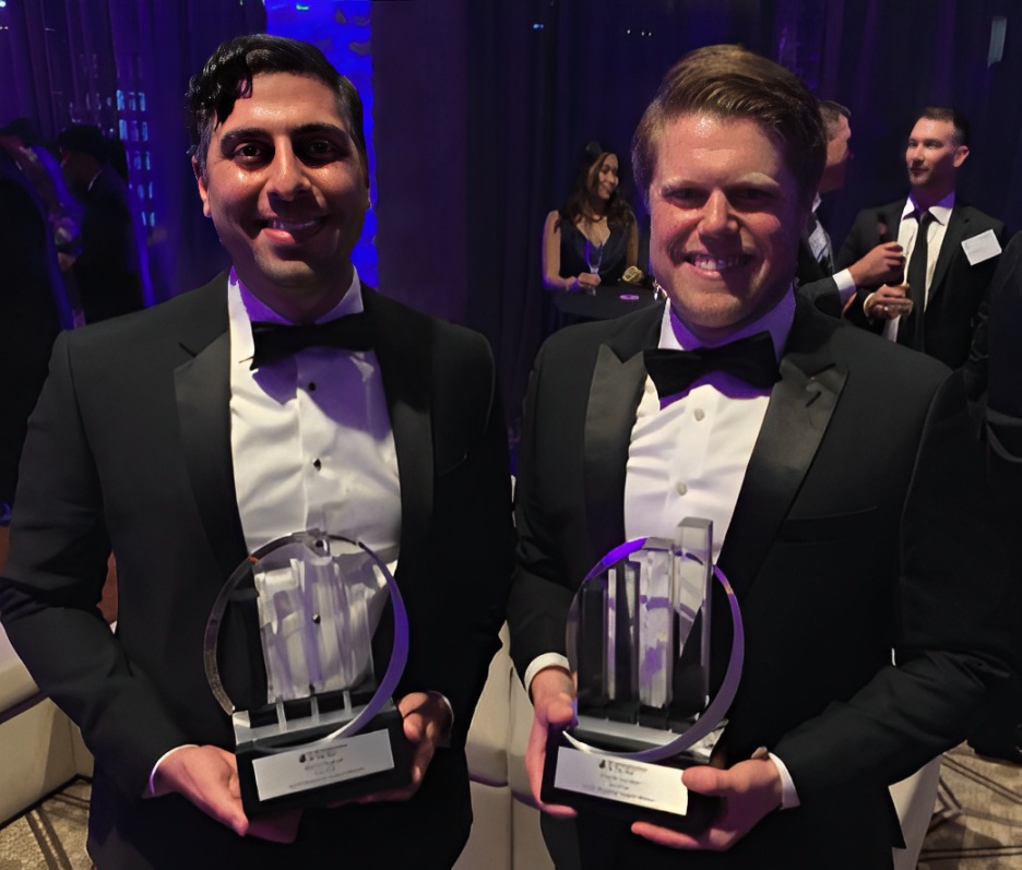 Mario Feghali, left, and Chuck Gordon, right, in formal wear holding awards