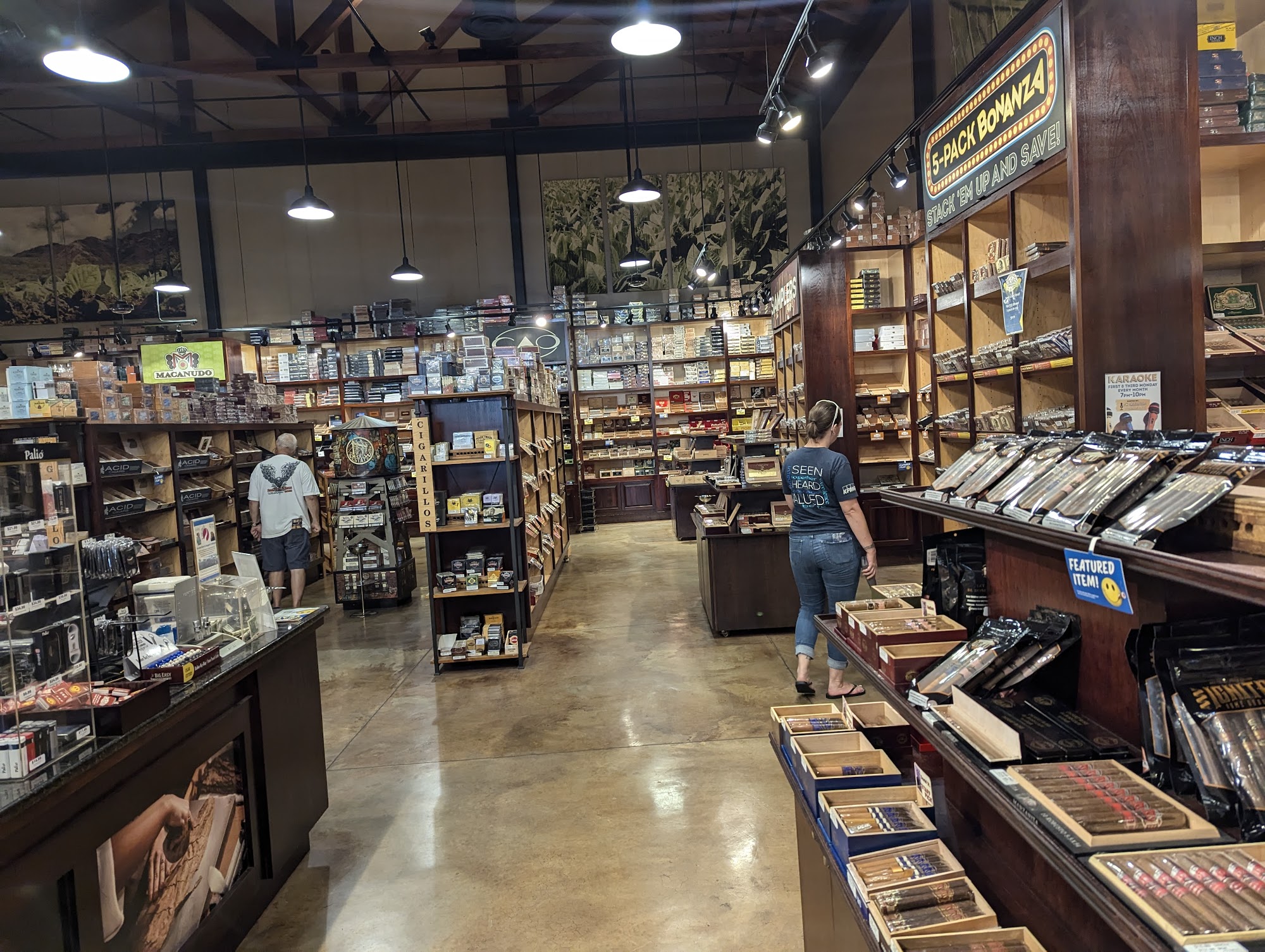 Rows of cigar boxes and wooden displays inside the Cigars International Hamburg superstore