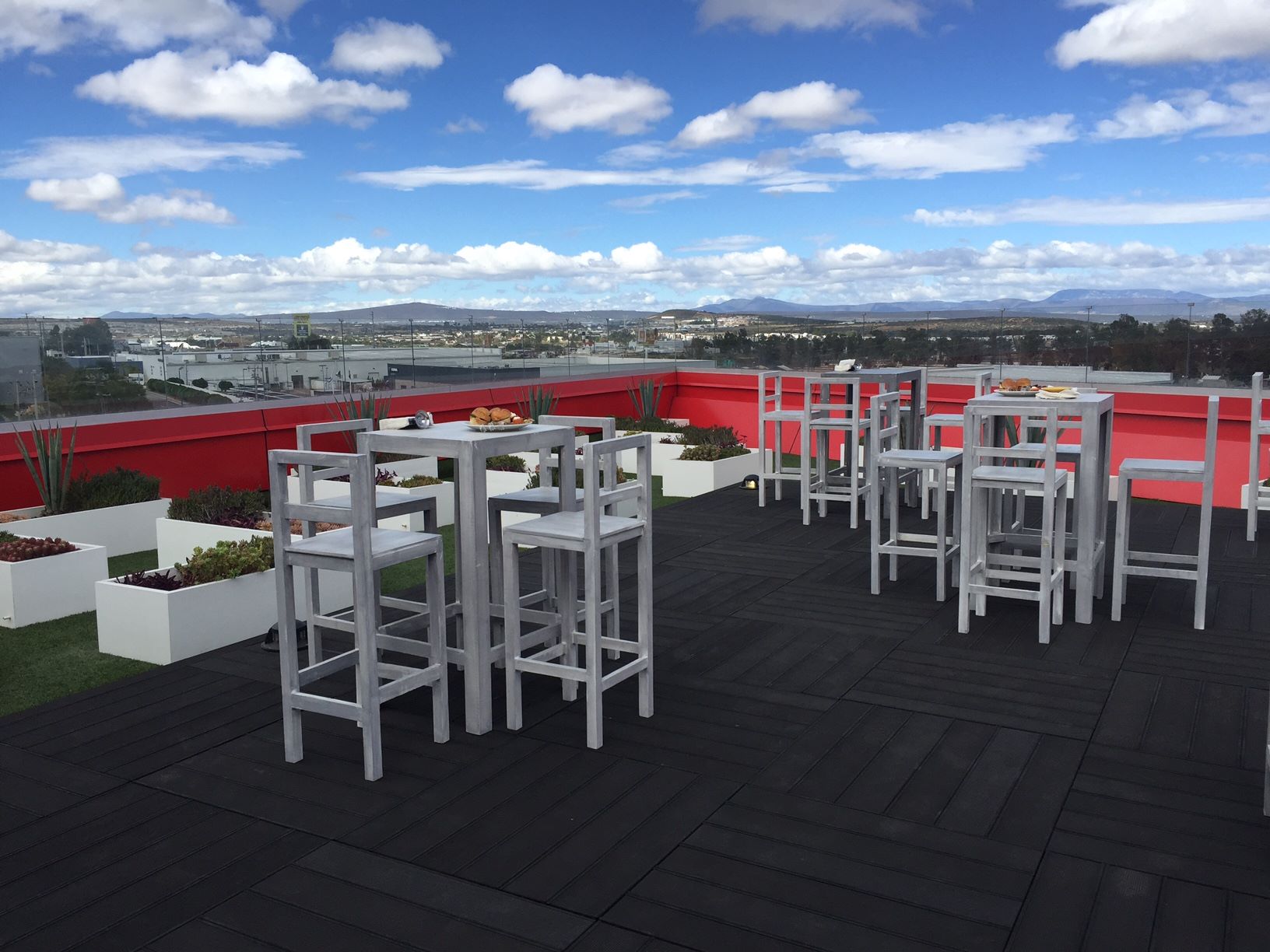 Ciinova rooftop terrace with tables, chairs and a view across Querétaro